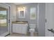 Bathroom with modern fixtures, a large mirror, and an exterior door to a patio at 10101 Langan St, Spring Hill, FL 34608