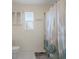 Cozy bathroom with shower/tub combination, decorative shower curtain, and a small window for natural light at 10101 Langan St, Spring Hill, FL 34608