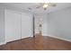 Bedroom featuring hardwood floors, ceiling fan and a large closet with an open door at 10101 Langan St, Spring Hill, FL 34608