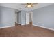 Bedroom featuring hardwood floors, ceiling fan, and an open door at 10101 Langan St, Spring Hill, FL 34608