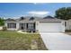 Charming single-story home with a two-car garage and dormer windows at 10101 Langan St, Spring Hill, FL 34608