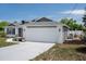 Charming home showcasing a white brick exterior, a two-car garage, and a well-manicured front lawn at 10101 Langan St, Spring Hill, FL 34608