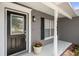 Close-up of the front door showcasing the entrance and house number with a porch and window at 10101 Langan St, Spring Hill, FL 34608