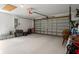 Spacious garage with a white painted floor, a large garage door, and storage along the walls at 10101 Langan St, Spring Hill, FL 34608