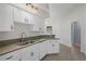 Bright kitchen featuring white cabinetry, granite countertops, and modern stainless steel appliances at 10101 Langan St, Spring Hill, FL 34608