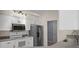 Modern kitchen featuring stainless steel appliances, white cabinets, and sleek countertops at 10101 Langan St, Spring Hill, FL 34608