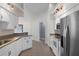 Bright kitchen with stainless appliances, white cabinets, light countertops, and tile floor at 10101 Langan St, Spring Hill, FL 34608