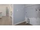 View of the laundry room showcasing its gray walls and access to the kitchen at 10101 Langan St, Spring Hill, FL 34608