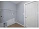 Laundry room with a gray painted wall and a shelf for storage at 10101 Langan St, Spring Hill, FL 34608