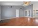 Spacious living area with wood floors, high ceilings, and doors leading to other rooms at 10101 Langan St, Spring Hill, FL 34608