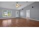 Spacious living room features wood floors, vaulted ceiling, front door, and an open floor plan at 10101 Langan St, Spring Hill, FL 34608