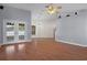 Open living room with hardwood floors, neutral paint, and access to the enclosed porch at 10101 Langan St, Spring Hill, FL 34608