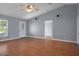 Open living room with wood floors, vaulted ceiling, front door, and access to other rooms at 10101 Langan St, Spring Hill, FL 34608