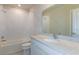Bright bathroom with white subway tiles in the shower, and a vanity with white cabinets and marble countertops at 10516 Hidden Banks Gln, Parrish, FL 34219