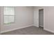 Bright bedroom with a window, closet and neutral carpet, creating a relaxing and comfortable space at 10516 Hidden Banks Gln, Parrish, FL 34219