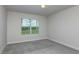 Cozy bedroom with neutral-toned carpet, a large window for natural light, and a clean, simple design at 10516 Hidden Banks Gln, Parrish, FL 34219