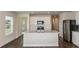 Bright kitchen with an island, stainless steel appliances, and white cabinets providing a modern, functional design at 10516 Hidden Banks Gln, Parrish, FL 34219