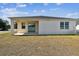 The property features a cozy covered patio and a well-maintained backyard, perfect for relaxing outdoors at 10628 Massimo Dr, Wimauma, FL 33598