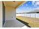 Backyard with a concrete patio and a white privacy fence at 10628 Massimo Dr, Wimauma, FL 33598