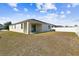 The property features a spacious backyard with a white fence, ideal for outdoor activities and privacy at 10628 Massimo Dr, Wimauma, FL 33598