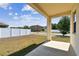 View of the backyard, framed by the porch and support beam, showing a fence at 10628 Massimo Dr, Wimauma, FL 33598