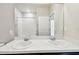 Bathroom features a double sink vanity with white countertop, and a walk in shower at 10628 Massimo Dr, Wimauma, FL 33598