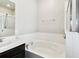 This bathroom features a bathtub and a shower and a marble countertop with a sink at 10628 Massimo Dr, Wimauma, FL 33598