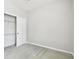 This is a view of a bedroom with a closet, a window, and carpet at 10628 Massimo Dr, Wimauma, FL 33598