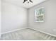 Carpeted bedroom with a ceiling fan, a window, and light grey walls at 10628 Massimo Dr, Wimauma, FL 33598