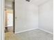 Neutrally painted bedroom with carpet floors, closet and an opening to another room at 10628 Massimo Dr, Wimauma, FL 33598