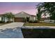 Charming one-story home with a two-car garage, manicured lawn and walkway to the front door at 10628 Massimo Dr, Wimauma, FL 33598