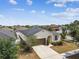 Inviting home featuring a well-kept lawn, mature trees, and a convenient two-car garage, enhancing curb appeal at 10628 Massimo Dr, Wimauma, FL 33598