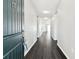 Inviting entryway with sleek, dark wood floors leading into the bright, modern living spaces at 10628 Massimo Dr, Wimauma, FL 33598