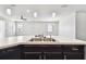 Kitchen island featuring pendant lighting and barstool seating into an adjacent living area at 10628 Massimo Dr, Wimauma, FL 33598