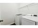 Well-lit laundry room featuring modern washer and dryer with wire shelving at 10628 Massimo Dr, Wimauma, FL 33598