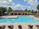 Community pool and adjacent picnic area has an abundance of lounge chairs for residents to use at 10628 Massimo Dr, Wimauma, FL 33598