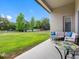 Spacious backyard patio with furniture and a view of the large lawn and mature trees at 1104 Isobel Reserve Ln, Tampa, FL 33613