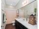 Bathroom featuring a large mirror, white countertop, and modern fixtures at 1104 Isobel Reserve Ln, Tampa, FL 33613