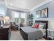 Comfortable bedroom with blue walls, a dark wood bed frame, and a collection of playful decor at 1104 Isobel Reserve Ln, Tampa, FL 33613
