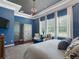 Stylish bedroom with tray ceiling, neutral decor, and a large window for plenty of natural light at 1104 Isobel Reserve Ln, Tampa, FL 33613
