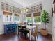 Elegant dining room featuring wainscoting, chandelier lighting, and large windows with a view at 1104 Isobel Reserve Ln, Tampa, FL 33613