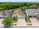 Charming home with a terracotta roof, three-car garage, and lush landscaping creating curb appeal at 1104 Isobel Reserve Ln, Tampa, FL 33613