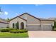 Beautiful one-story home featuring a well-manicured lawn, brick driveway and lovely landscaping at 1104 Isobel Reserve Ln, Tampa, FL 33613