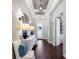 A long foyer featuring hardwood floors, unique lighting fixtures, and a view of the office space at 1104 Isobel Reserve Ln, Tampa, FL 33613