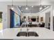Open kitchen and living area featuring stainless steel appliances, island seating, and an airy atmosphere at 1104 Isobel Reserve Ln, Tampa, FL 33613