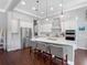 Modern kitchen with stainless steel appliances, white cabinets, and a large center island at 1104 Isobel Reserve Ln, Tampa, FL 33613