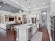 Open concept kitchen with a large island, stainless appliances, and adjacent living area at 1104 Isobel Reserve Ln, Tampa, FL 33613