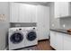 Functional laundry room featuring modern appliances, ample storage cabinets, and a convenient folding area at 1104 Isobel Reserve Ln, Tampa, FL 33613