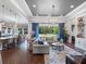 Open-concept living room boasts hardwood floors, large windows, and comfortable seating with a view at 1104 Isobel Reserve Ln, Tampa, FL 33613