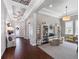 An elegant living room featuring tray ceilings, hardwood floors and cozy seating area at 1104 Isobel Reserve Ln, Tampa, FL 33613